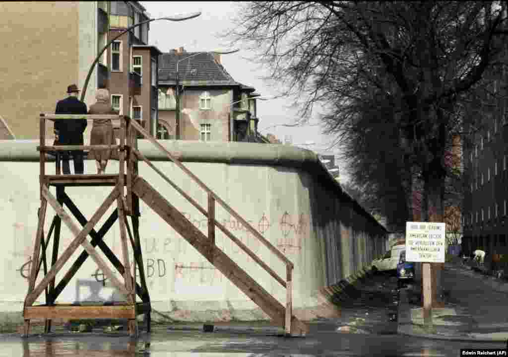 A couple look over the wall into East Berlin in April 1983.&nbsp;&nbsp; Salter says the testing of anti-vehicle barriers was only one part of a vast research-and-development effort to trap people inside the police state. The Berlin Wall design itself, he says, was trialled &quot;for its resistance to attacks with vehicles, explosives, and how it would withstand natural events such as being washed away by water during heavy rainfall.&quot;