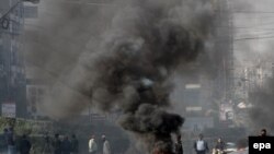 Supporters of opposition party Pakistan Tehreek-e-Insaf (PTI), burn tires during a protest in Karachi on December 12.