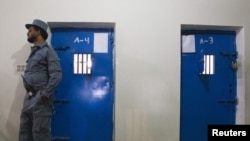 Afghanistan - An Afghan policeman stands in front of cells in a prison in the town of Lashkar Gah in Helmand province, southern Afghanistan, 19Jul2011