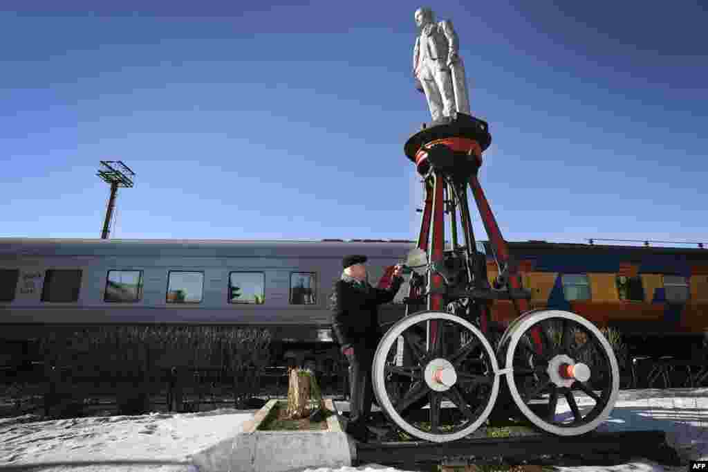 A railroad museum employee shows a wheeled monument to the founder of the Soviet state, Vladimir Lenin, in Moscow. It is one of 16 such monuments created in 1925, one year after Lenin's death, by Moscow's railroad workers to promote his ideas in remote areas. (AFP/Alexander Nemenov)