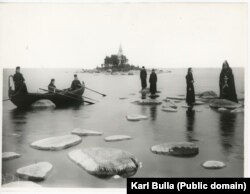 Monks from the Konevsky Monastery pose on the stones of Lake Ladoga, just north of St. Petersburg, around 1900.