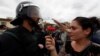 A woman gives a carnation to a Spanish Civil Guard officer outside a polling station in Sant Julia de Ramis, Spain on October 1, 2017.