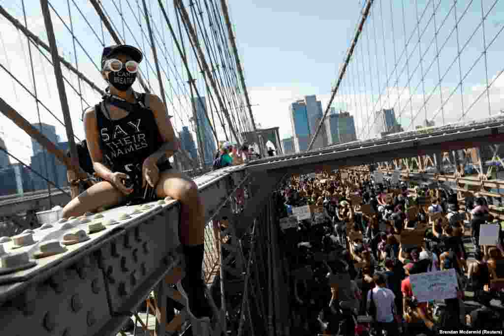 People march during events to mark Juneteenth, which commemorates the end of slavery in Texas, two years after the 1863 Emancipation Proclamation freed slaves elsewhere in the United States, amid nationwide protests against racial inequality, at the Brooklyn Bridge, in New York City, New York, U.S., June 19, 2020. 