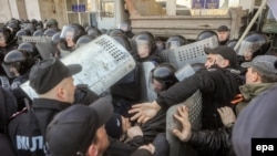 Pro-Russian protesters clash with police as they try to occupy a regional administration building in Donetsk earlier this week. Russian media are reporting that staff from a U.S. military contractor have been assisting Kyiv authorities in eastern Ukraine. 