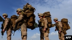 U.S. Marines board a transport aircraft headed to Kandahar as British and U.S. forces withdrew from the Camp Bastion-Leatherneck complex in Helmand province on October 27.