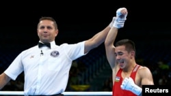 Hasanboy Dusmatov of Uzbekistan reacts after winning his bout over American Nico Miguel Hernandez.