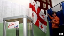 A member of a Georgian voting commission prepares a polling station before the 2008 presidential vote.