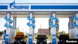 Russia -- Vehicles are seen at a gas filling station, owned by Gazprom Transgaz Stavropol, with the company logo of Russian natural gas producer Gazprom seen on the station, in Stavropol, October 9, 2013