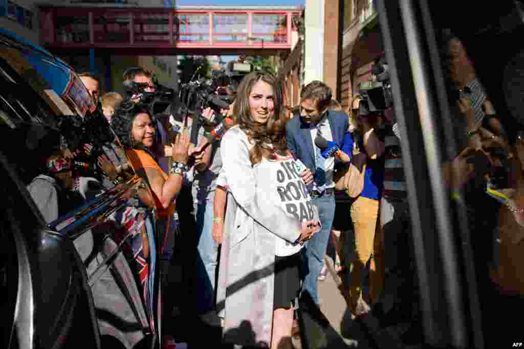 A look-alike of the Duchess of Cambridge poses for photographers.