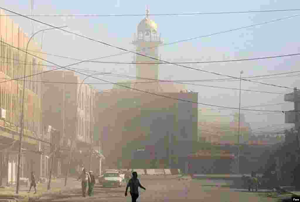 Dust rising from the mosque after the June 13, 2007, attack that brought down both minarets (Fars) - Al-Mutawakkil thus brought Imam Ali and Hasan to Samarra in 848 and imprisoned them inside a military fort. Henceforth they became known as al-Askari (military) because of the location of their imprisonment.