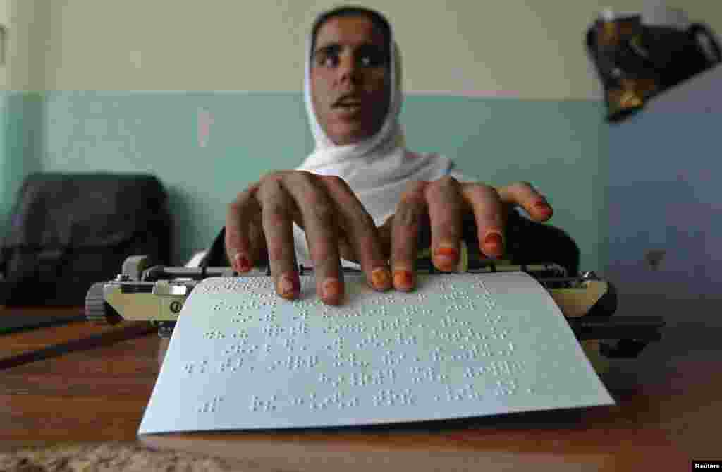 A blind student reads Braille during a lesson at the school.