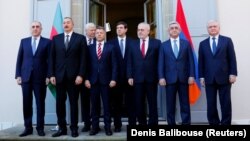 SWITZERLAND -- Azerbaijani Foreign Minister Elmar Mammadyarov, Azerbaijani President Ilham Aliyev, Armenian President Serzh Sarkisian and Armenia's Foreign Minister Edward Nalbandian pose next to OSCE delegates at the opening of talks in Geneva, October 16.