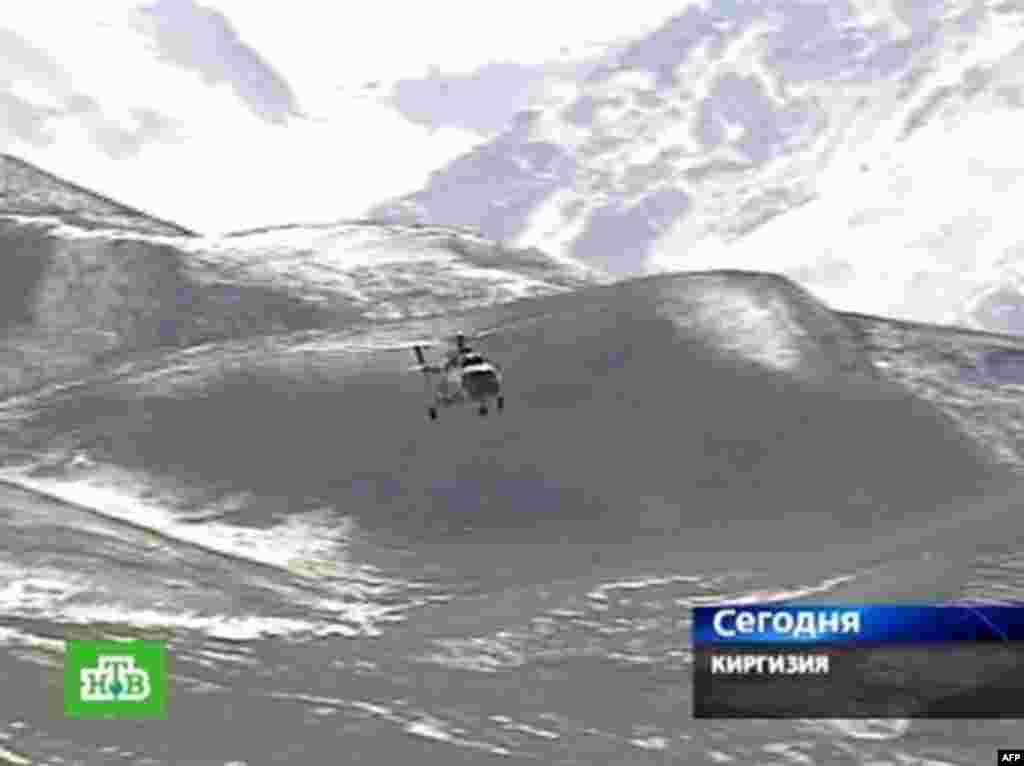 A helicopter from the Kyrgyz Emergencies Ministry flies to the devastated village of Nura. - A Russian NTV channel television grab shows a Kyrgyz Emergencies Ministry helicopter at an unnamed location near Osh flying to the village of Nura in the isolated Alaisky district on October 6, 2008. A strong earthquake hit Kyrgyzstan, killing 65 people mainly in a remote village near the border with China that rescuers were racing to reach, officials said.