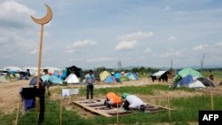 Greece -- Muslims pray at a makeshift camp for migrants and refugees near the village of Idomeni not far from the Greek-Macedonian border, May 2, 2016