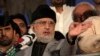 Tahir ul-Qadri, Sufi cleric and leader of political party Pakistan Awami Tehreek, gestures as he addresses to his supporters outside the parliament house in Islamabad August 21, 2014. 