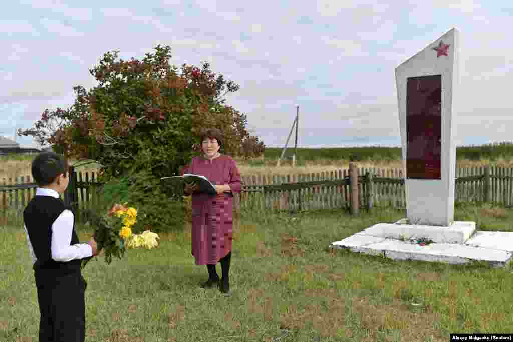 Ravil Izhmukhametov, 9, and teacher Uminur Kuchukova, 61, during a ceremony on the first day of the new school year in Sibilyakovo village, in Russia&rsquo;s Omsk region. Kuchukova has worked at the school for 42 years. She could have retired long ago but continues to teach for the sake of Izhmukhametov, the school&#39;s last pupil.