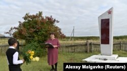 Ravil Izhmukhametov, 9, and teacher Uminur Kuchukova, 61, during a ceremony on the first day of the new school year in Sibilyakovo village, in Russia’s Omsk region. Kuchukova has worked at the school for 42 years. She could have retired long ago but continues to teach for the sake of Izhmukhametov, the school's last pupil.