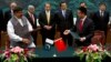 File photo of Pakistani Prime Minister Nawaz Sharif (center L) and Chinese Premier Li Keqiang (center R) observe a signing ceremony.