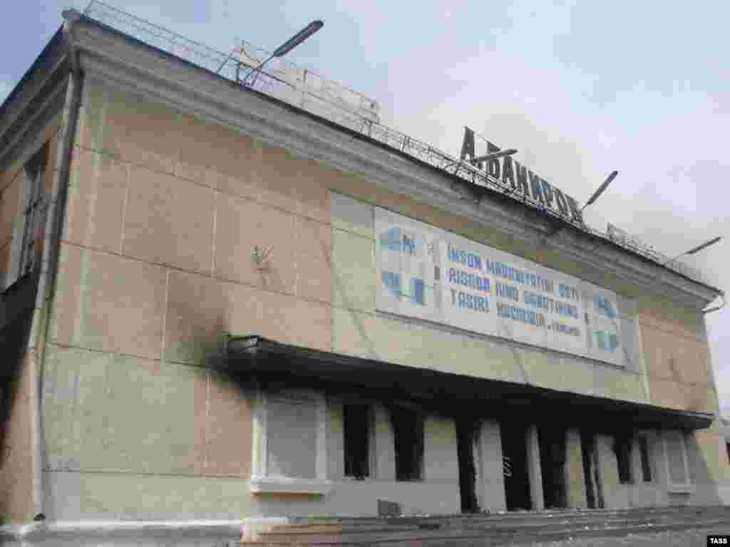 A local drama theater shows fire damage from the May 2005 tumult - Emotions had been stirred up by the trials of a group of local businessmen, accused of separatism. The night before the shootings to disperse the crowd, militants forcibly freed the businessmen from prison, apparently along with other prisoners, and they occupied a government building. 