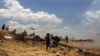 Free Syrian Army fighters fire rockets towards government forces in the northern countryside of Quneitra, in the Golan, June 17, 2015