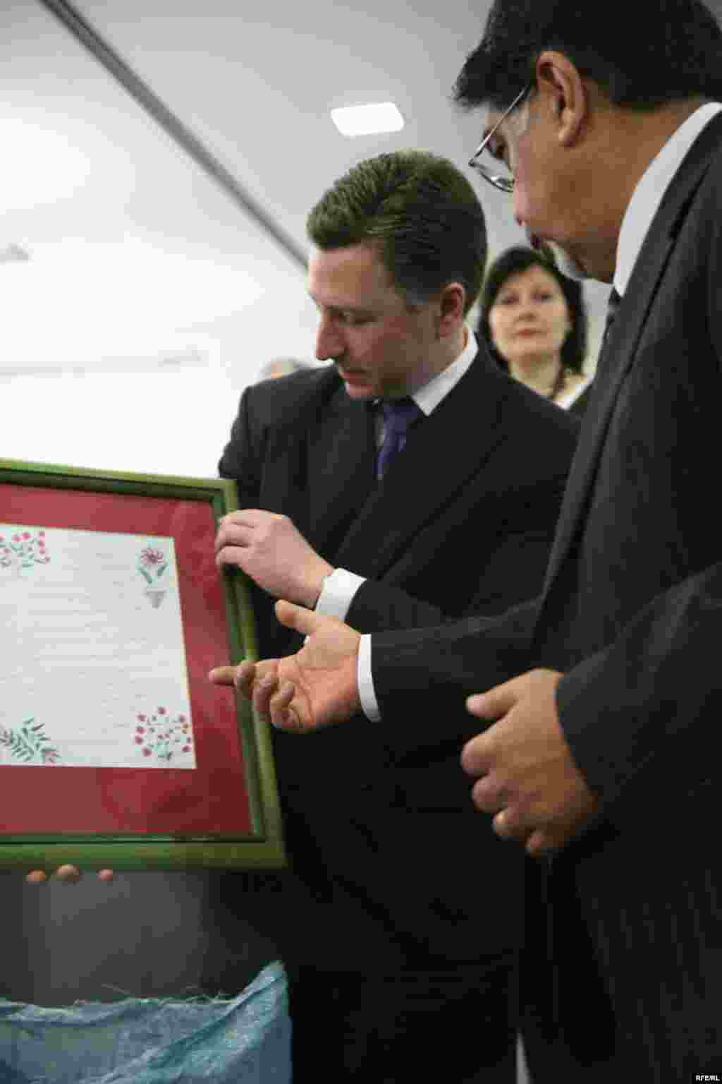 The Ambassador is presented with a framed letter from a Radio Free Afghanistan listener