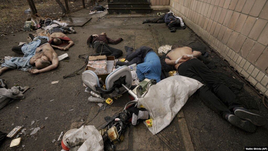 The bodies of men, some with their hands tied behind their backs, lie on the ground in Bucha on April 3.