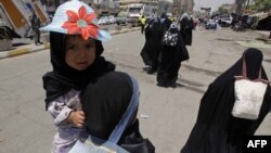 Shi'ite pilgrims travel to the Kadhimiya shrine in north Baghdad on June 14 to commemorate the death anniversary of Imam Musa Kadhim.