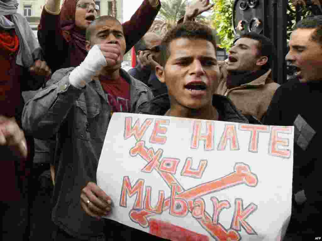 Anti-government demonstrators shout slogans in Cairo on January 27.