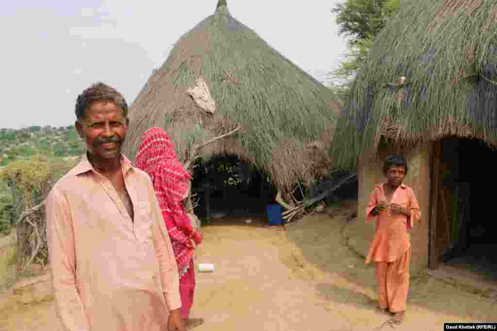 Bhutto, 35 and his wife, Babri, 30, travel to the neighboring districts of Punjab Province to harvest wheat, which feeds them for three to four months. Bhutto says the recent rains have made them happy because their goats are getting fat.