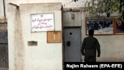 A security official stands guard outside the office of International Committee of Red Cross (ICRC) in Kunduz on October 9.