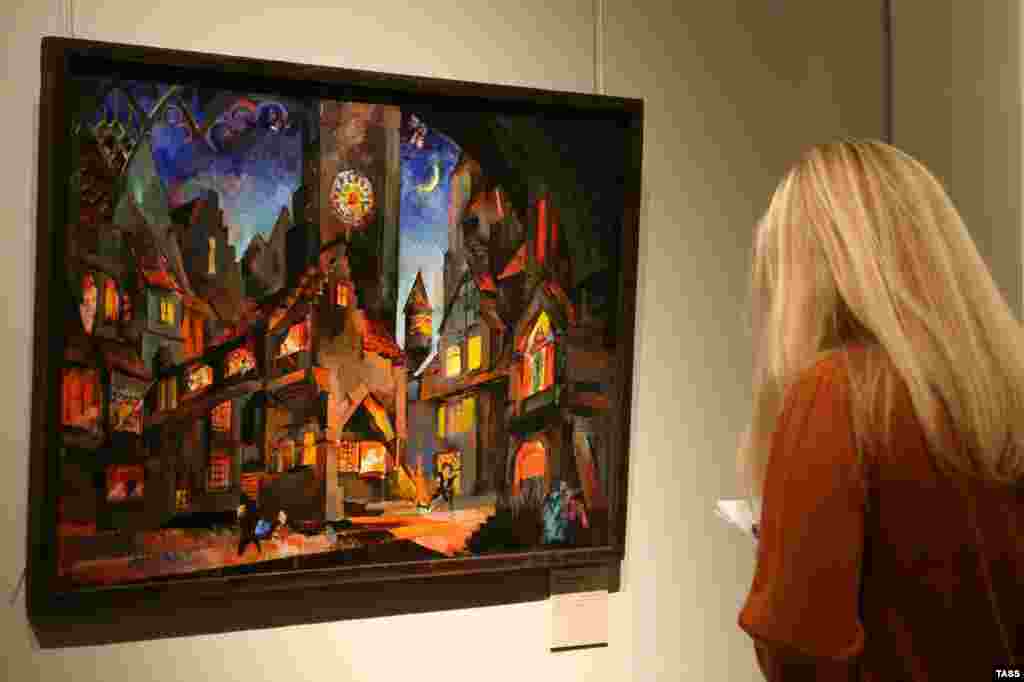 A visitor looks at artist Fyodor Fedorovsky's sketch of stage sets for a performance of Wagner's work at the Bolshoi Theater.