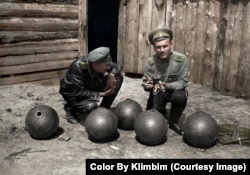 Russian soldiers with a lineup of bombs during World War I.