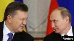 Russia's generous offer of cheaper gas and financial aid is seen by many as an attempt by President Vladimir Putin (right) to shore up his embattled Ukrainian counterpart Viktor Yanukovych (left) and keep Kyiv in the Kremlin's orbit.