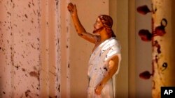 Bloodstains are seen on the wall and on a statue of Jesus Christ at St. Sebastian's Church after an attack in Negombo, north of Colombo, Sri Lanka, on April 21.