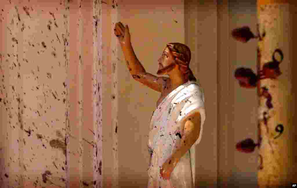 Blood stains are seen on a statue of Jesus Christ after a bomb exploded at St. Sebastian's Church in Negombo, Sri Lanka, on Sunday, April 21. A series of explosions involving suicide bombers at churches and hotels in Sri Lanka killed 259 people on Easter Sunday. Islamic State militants claimed responsibility for the attacks. (AP)