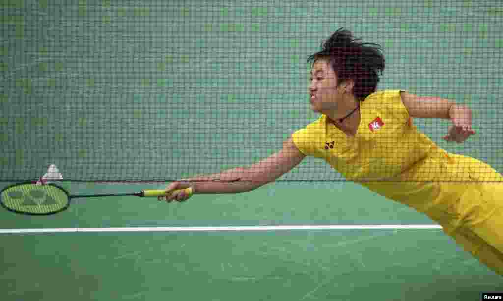 Yip Pui Yin of Hong Kong reaches for a shot during women's singles badminton group play against Kati Tolmoff of Estonia.