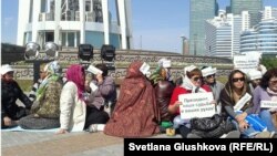 Some of those demonstrating at the Baitarek in downtown Astana on May 27 in favor of government intervention amid mounting foreclosures.
