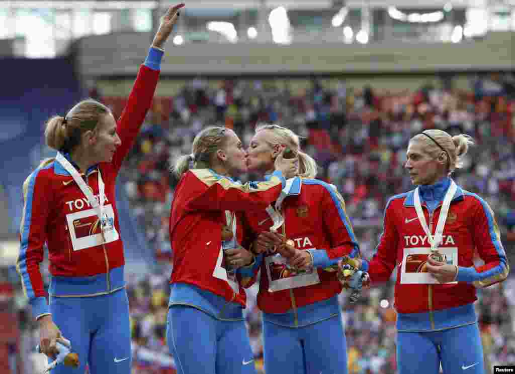 Members of Russia&#39;s 4x400 women&#39;s relay team celebrate their gold medal at the IAAF World Athletics Championships in Moscow. There has been widespread speculation that the kiss between Ksenia Ryzhova (left center) and Yulia Gushchina was in protest to Russia&#39;s controversial law banning so-called &quot;homosexual propaganda.&quot; The two have not commented. The other members of the winning team were Tatiana Firova (left) and Antonina Krivoshapka (right). (Reuters/Grigory Dukor)