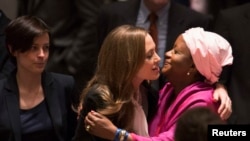 UN High Commissioner for Refugees (UNHCR) special envoy actress Angelina Jolie (center) greets UN Special Representative of the Secretary-General on Sexual Violence in Conflict Zainab Bangura before a United Nations Security Council session on June 24.