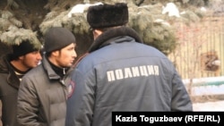 Two of the Uzbek asylum seekers wait outside the Almaty administrative court during their trial in January 2011.