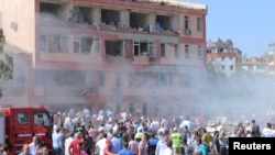 People rush to the scene of a bomb blast near a police station in the eastern Turkish city of Elazig on August 18.
