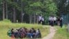 Bosnia and Herzegovina -- Police escorting migrants from temporary migrant camp Vucjak near Bihac, October 15, 2019.