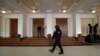 A prison guard walks outside a courtroom during an appeal by Yevgeny Nikulin, who faces charges of hacking computers of American companies, in Prague on November 24.