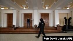 A prison guard walks outside a courtroom during an appeal by Yevgeny Nikulin, who faces charges of hacking computers of American companies, in Prague on November 24.