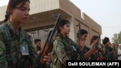 Syrian Democratic Forces fighters attend the funeral of four fellow fighters in the northeastern city of Qamishli in September.