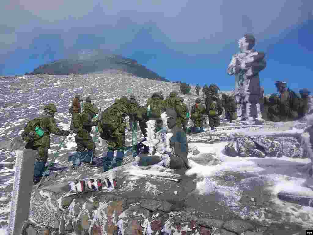 A handout picture provided by Japan's Self-Defense Forces shows Japanese Ground Self-Defense Force rescuers during a search-and-rescue operation near the peak of snow-covered Mount Ontake, which erupted on September 27. At least seven hikers are still missing on the volcano after it erupted unexpectedly. Fifty-six hikers died. (epa)