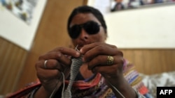Naziran, 25, an acid victim, knits at a rehabilitation center of the Acid Survivors Foundation in Islamabad.