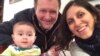 Iranian-British citizen Nazanin Zaghari-Ratcliffe (R) poses for a photograph with her husband Richard and daughter Gabriella, undated. File photo