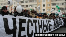 Protesters gather behind a banner reading "Honest Elections" during a demonstration in Moscow on February 4.
