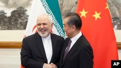 Chinese Foreign Minister Wang Yi meets Iranian Foreign Minister Mohammad Javad Zarif at the Diaoyutai State Guesthouse in Beijing, Friday, May 17, 2019. (Thomas Peter/Pool Photo via AP)